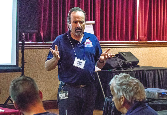 A man giving a speech in a conference room