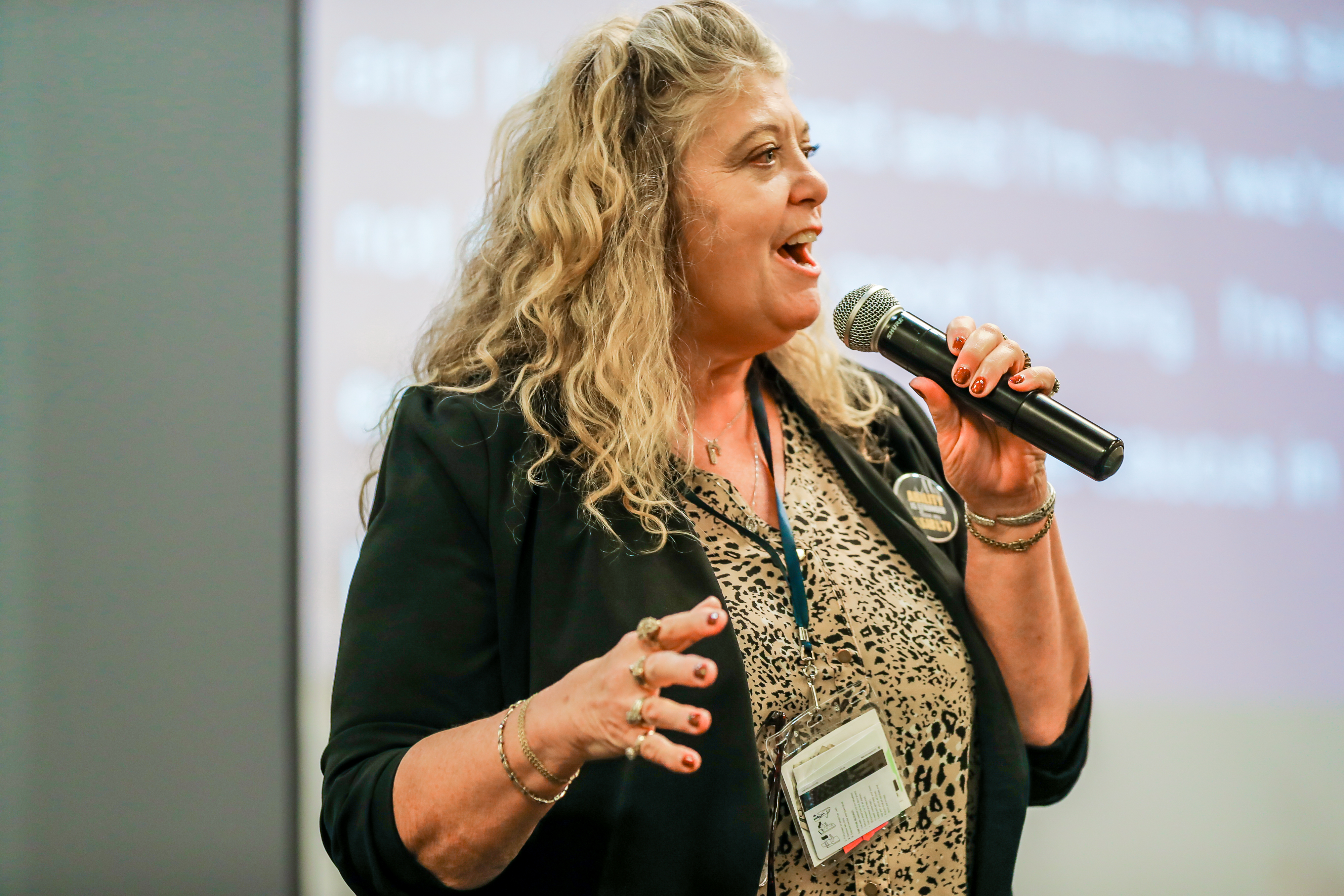 Shari Coatney, the director of SKIL Resource Center, speaks into the microphone and presents on advocacy during a breakout session.