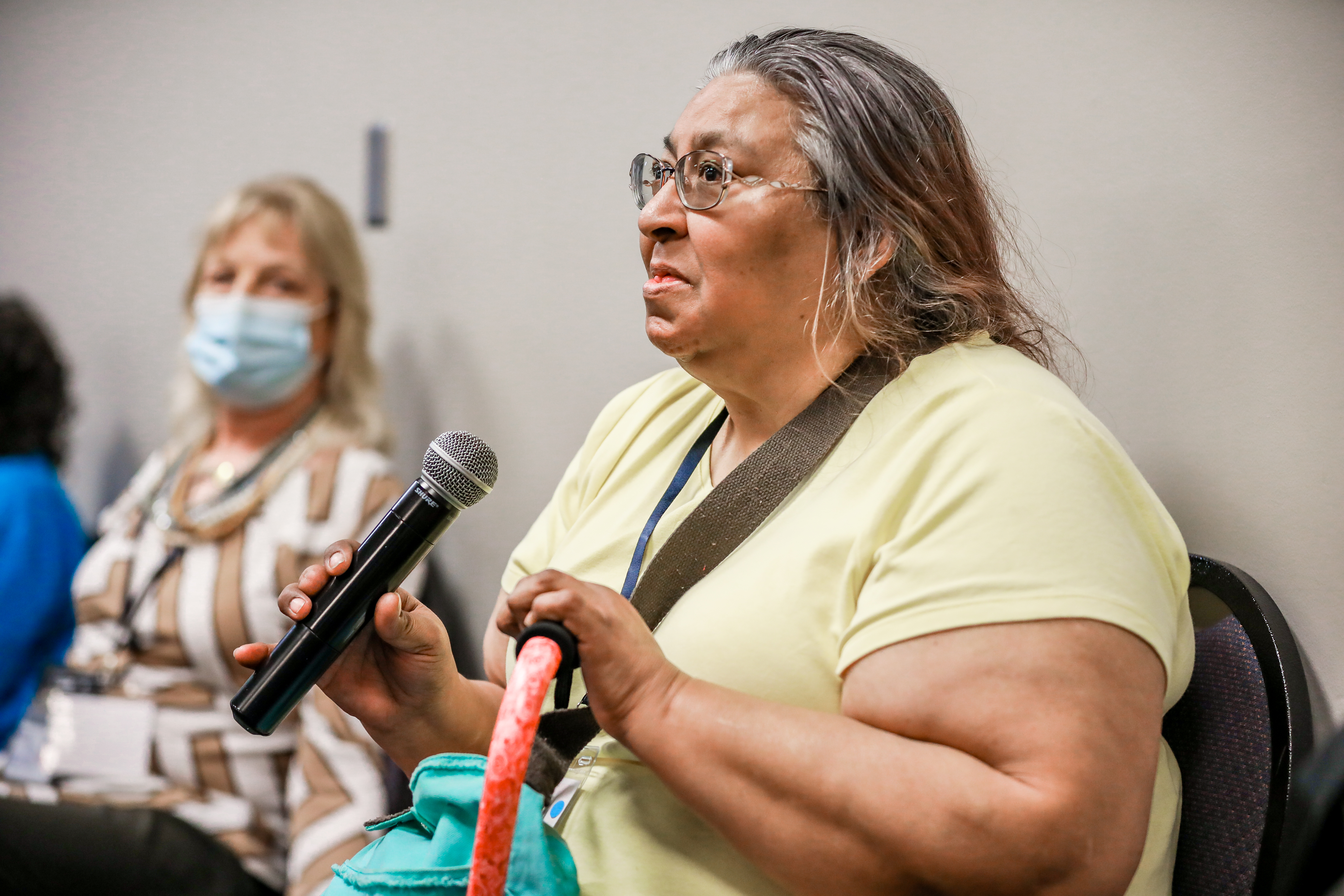 A female participant of the Caucus speaks into the microphone during a Caucus regional session.
